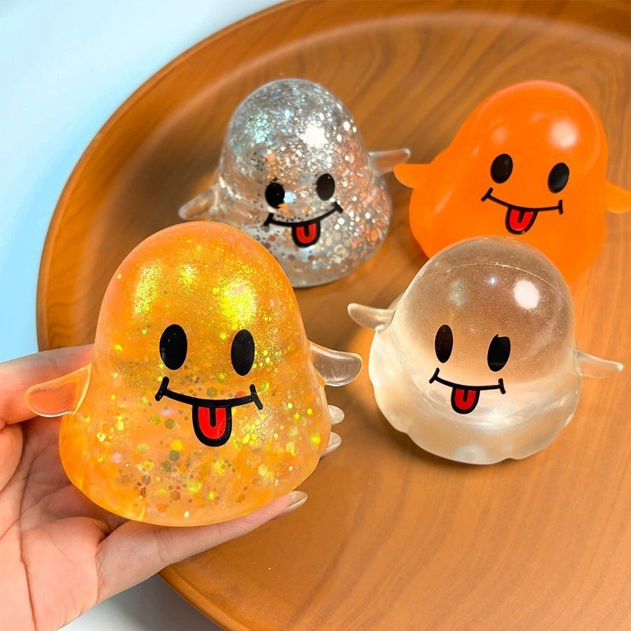 Hand squeezing a glitter ghost squishy with orange, silver and clear ghosts