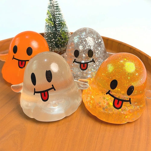 Glitter ghost squishies on a wooden tray