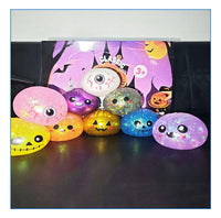Glitter Halloween squishy buns lined up: pumpkins, ghost and eyeball