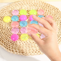 Hand squeezing mini glitter squishies from the advent calendar
