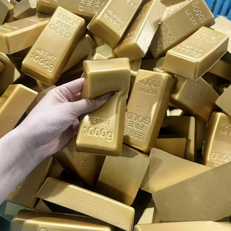 Hand squeezing a gold bar squishy