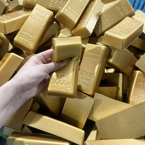 Hand squeezing a gold bar squishy
